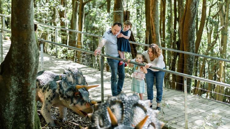 Family looks at dinosaurs at Scenic World, Blue Mountains