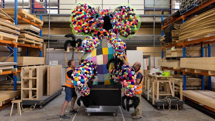 A giant koala made of colourful pom-poms under construction before heading to the Powerhouse Museum