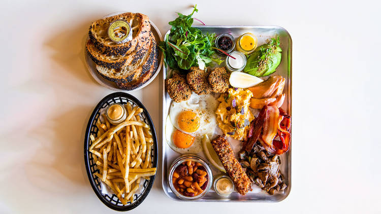 Breakfast platter at Happyfield featuring eggs, nine sides and sauces