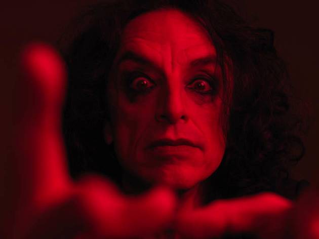 Paul Capsis, Rapture, Sydney Festival 2021 A close-up of Paul Capsis with dark eye makeup, bathed in red light