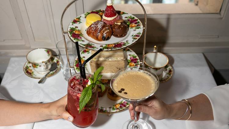 Two cocktails held at high tea tower display.