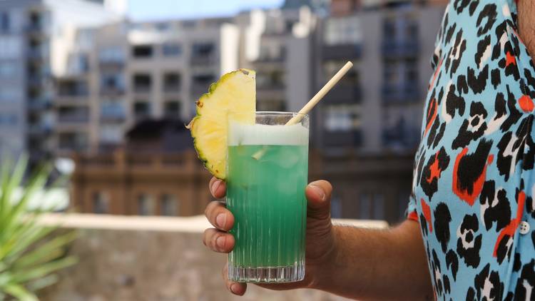 People enjoy cocktails on a rooftop