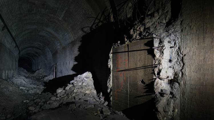 A spooky dark tunnel in blasted concrete and steel far below Sydney