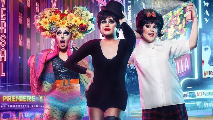 Three drag queens pose in theatre costumes