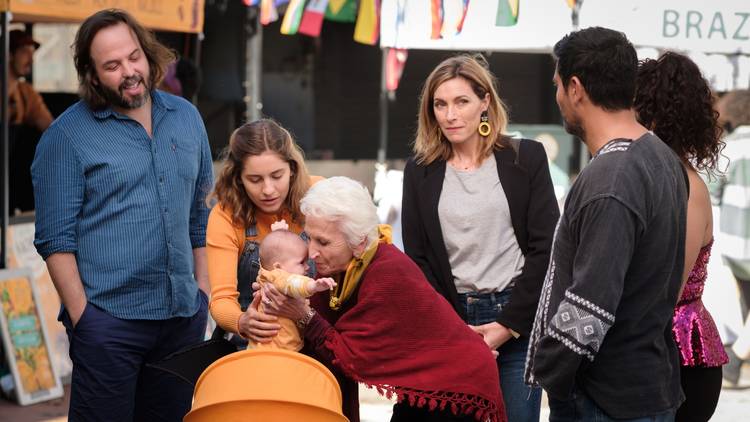 The two main families of bump congregate around the baby's pram, with actor Nathalie Morris at the centre as Olympia and coc-creator Claudia Karvan to one side as her mum Angie