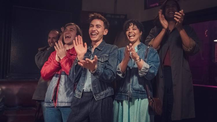 The cast of Stan show It's a Sin applauding in '80s attire