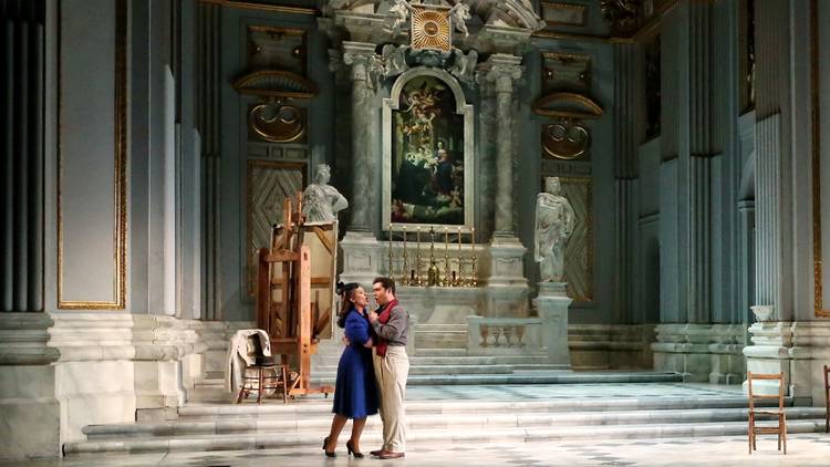 Carmen Giannattasio and Diego Torre embrace on a lush cathedral-like stage in Tosca