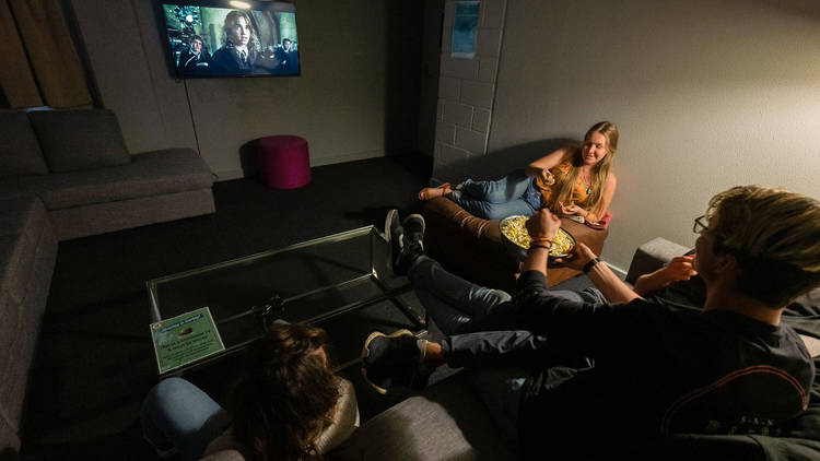 Friends hanging out in the TV room at Melbourne Metro