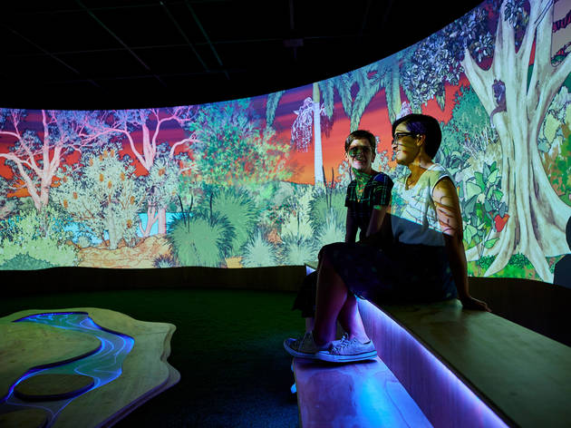 SLM Culture Up Late Two people sit in a video projection installation.
