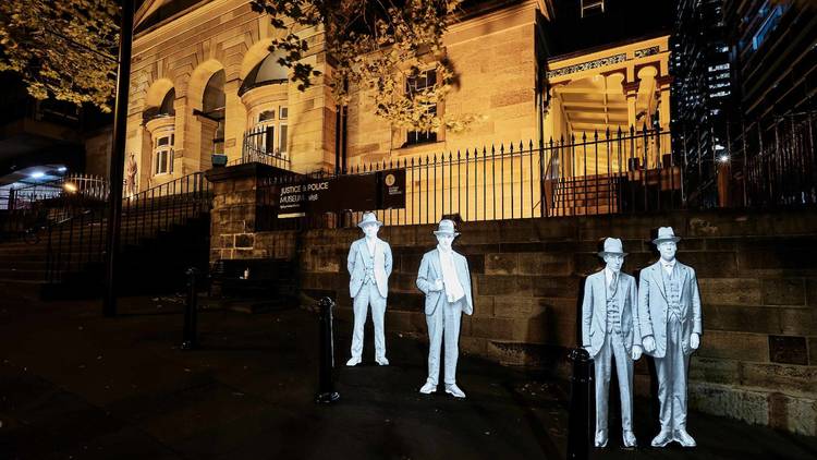 Cut-out figures outside the Justice and Police Museum at night