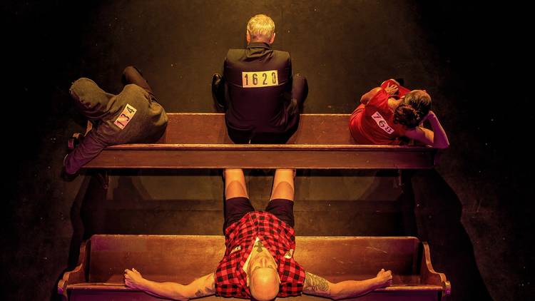 Four people sitting on two benches, taken from above