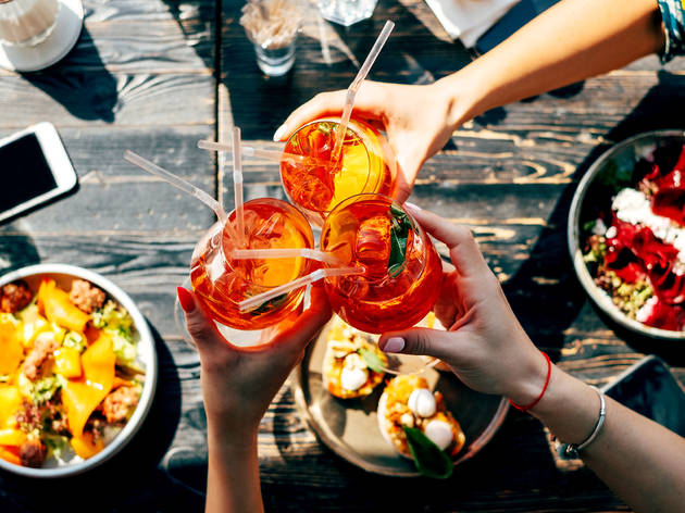 Friends,Toasting,,Saying,Cheers,Holding,Tropical,Aperol,Spritz,Cocktails.,Top Photograph: Shutterstock