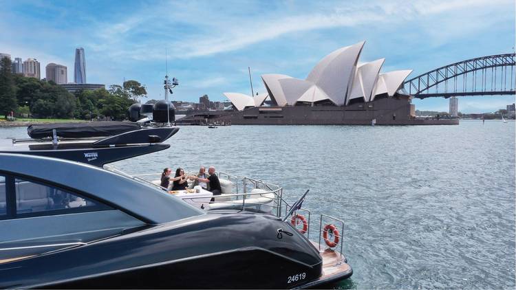 Four friends on a yacht near the Sydney Opera House