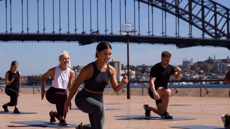 People doing fitness workout with Sydney Harbour Bridge in background