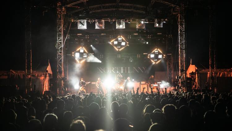 Metalcore band Northlane plays a concert to a huge outdoor crowd.