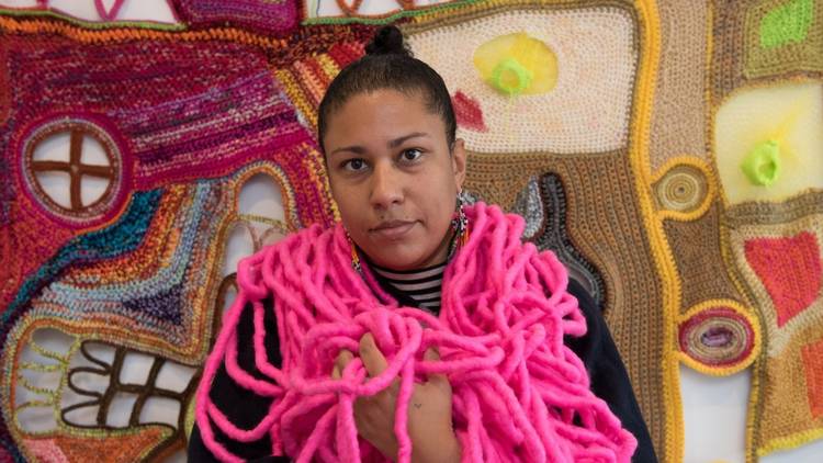 artist Paula do Prado wwearing neon pink textile art