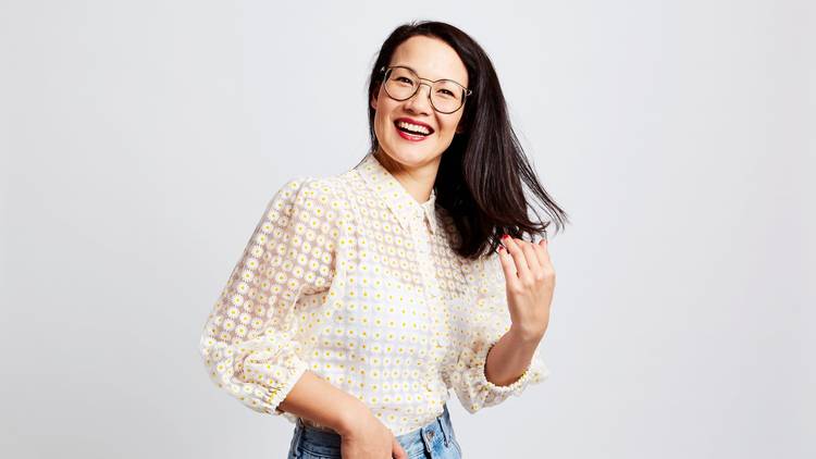  Comedian Lizzy Hoo in a white mesh shirt and glasses tosses her hair