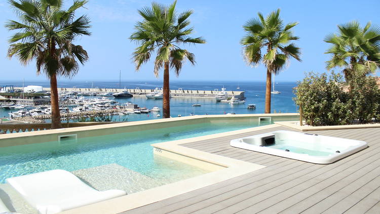 A swimming pool and palm trees at a luxury hotel in Mallorca.