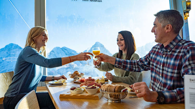 People eating at a mountain summit restaurant.