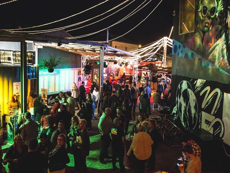 Crowd mingles in the forecourt of the Factory Theatre