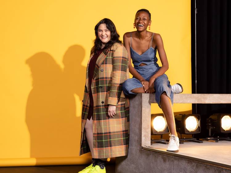 Moreblessing Maturure and Shari Sebbens laugh, set against a yellow backdrop