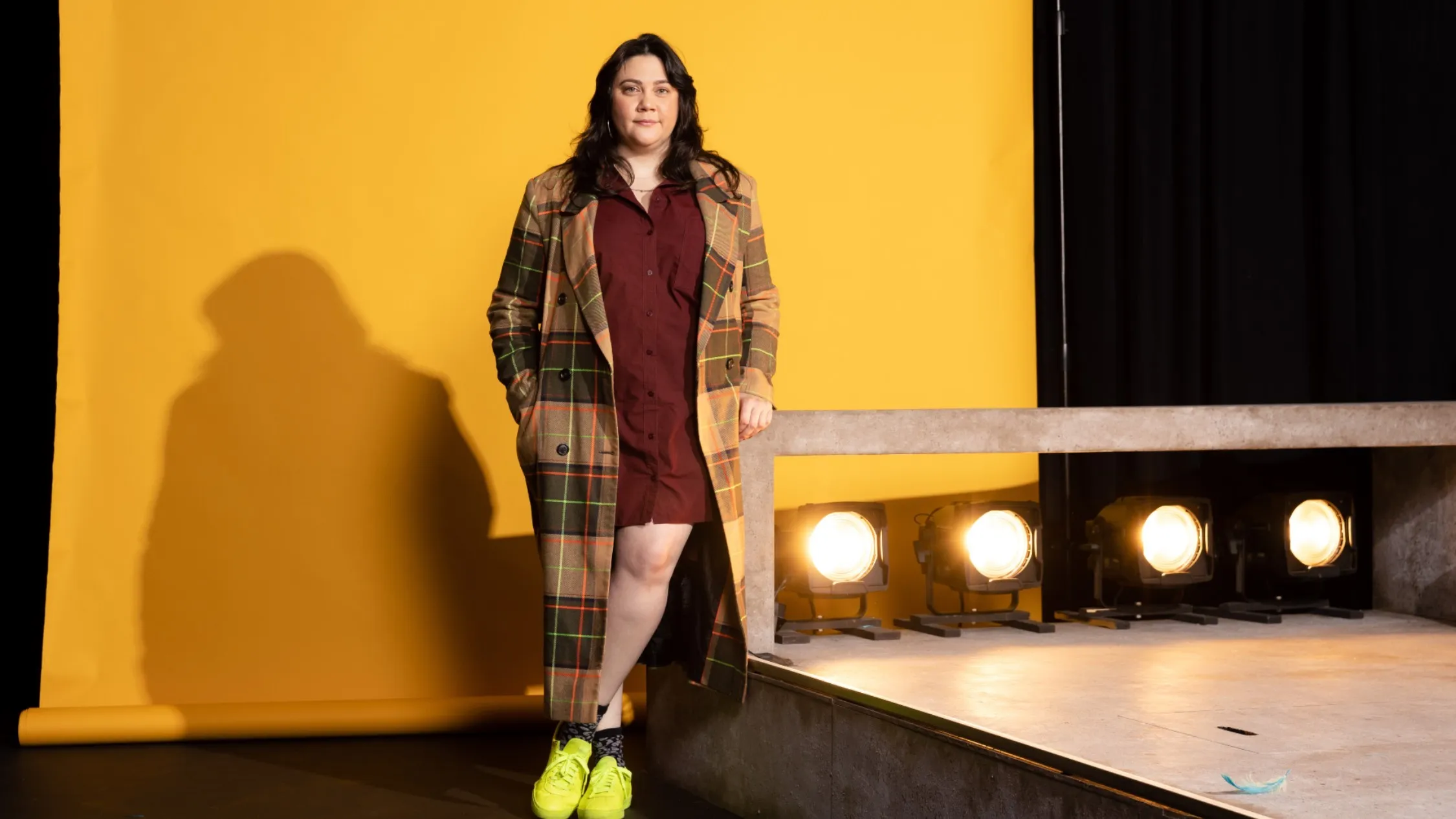 Shari Sebbens poses against a yellow backdrop