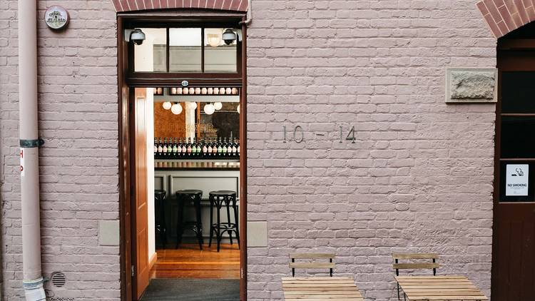 Pink wall with tables outside