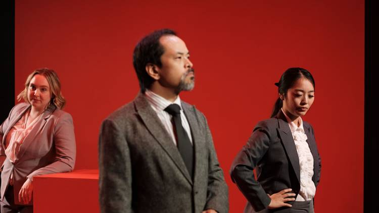 Three people pop against a red backdrop 