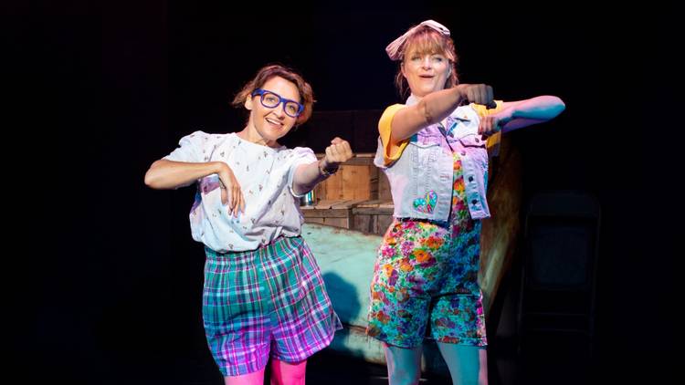 Two women dance in bright clothing