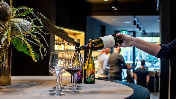 Person pouring wine