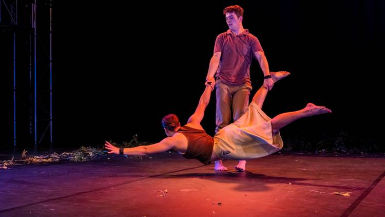 a man spins a woman just above the ground with his hands