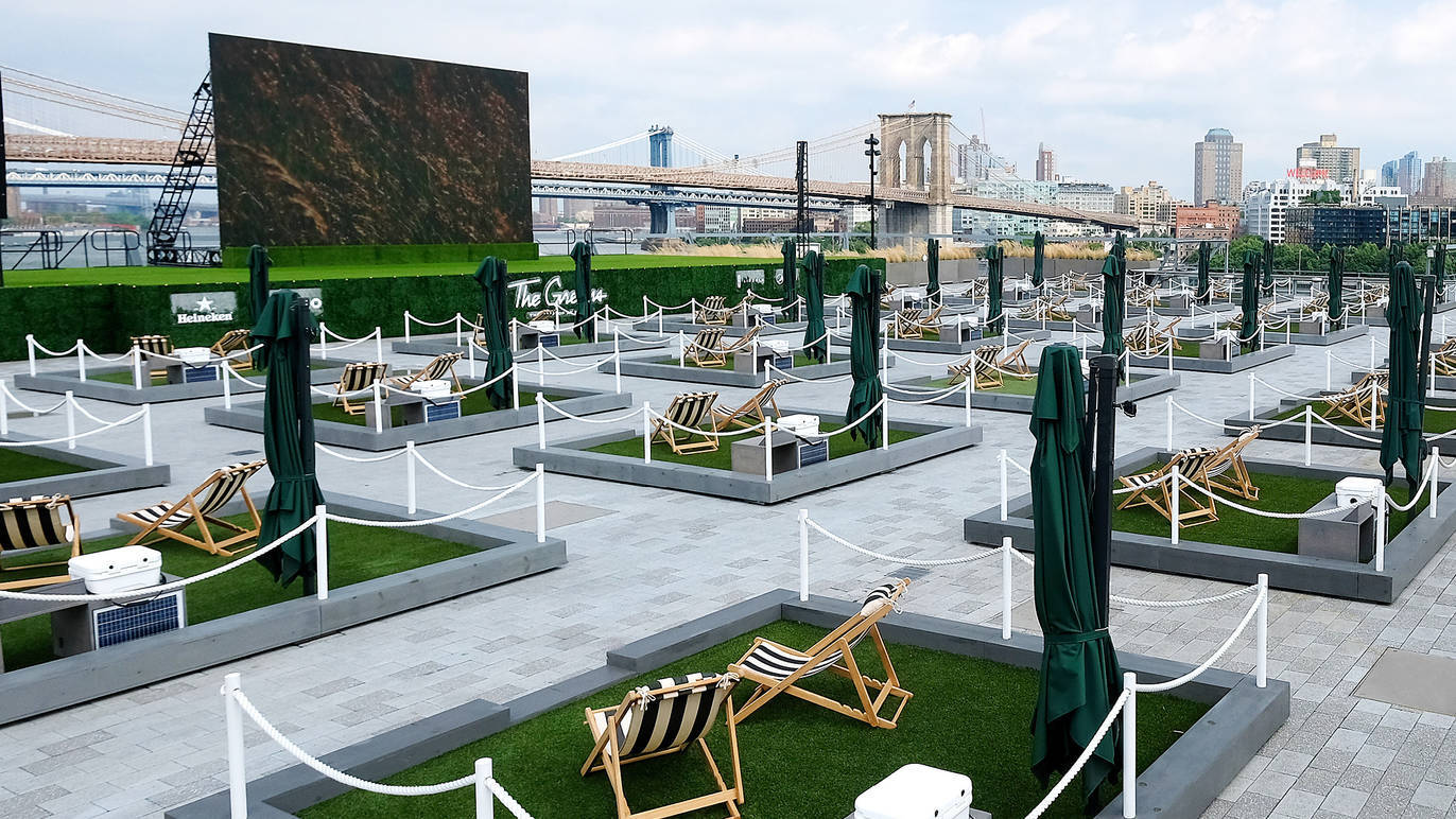 The Greens at Pier 17 has patches of grass, food, and drinks.