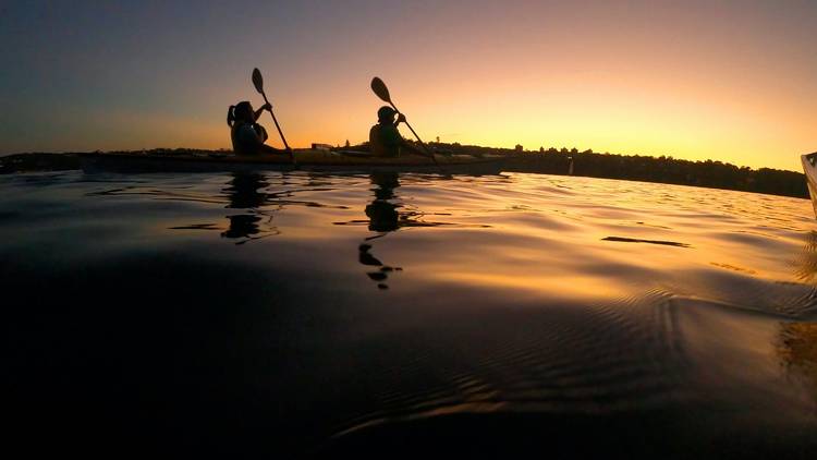 Explore the water at night aboard a kayak