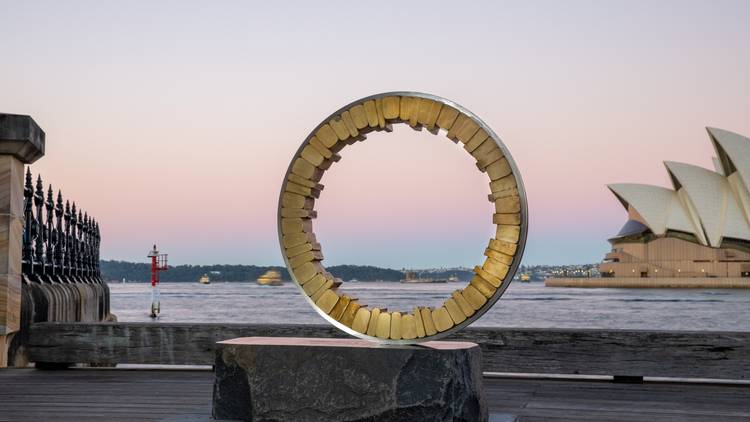 A circular sculpture with the Opera House as the backdrop