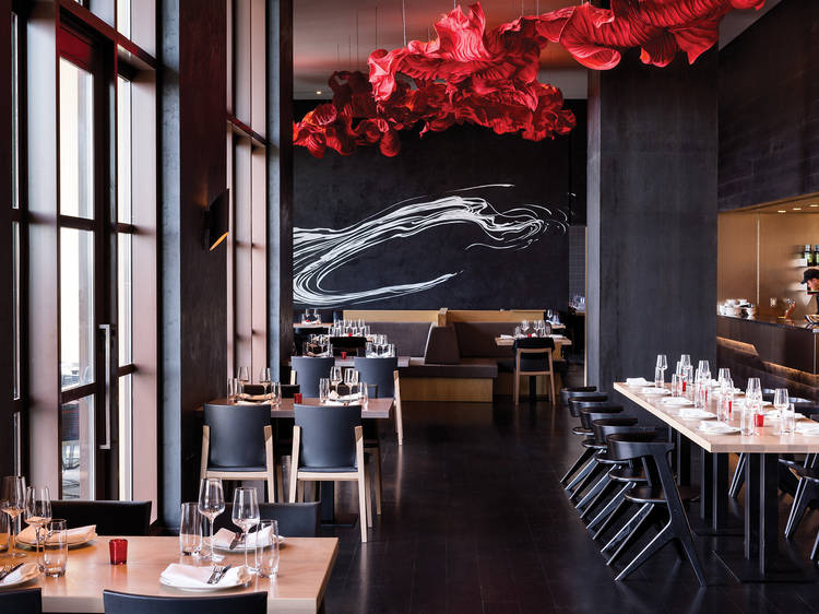 Interior of a restaurant with a red ceiling decoration.