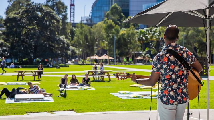 A musician performing in Tumbalong Park