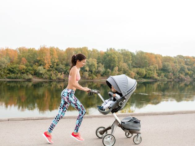Active,Mother,Jogging.,Jogging,Or,Power,Walking,Woman,With,Pram Active mother jogging. Jogging or power walking woman with pram at sunset. Mother with child in stroller running
