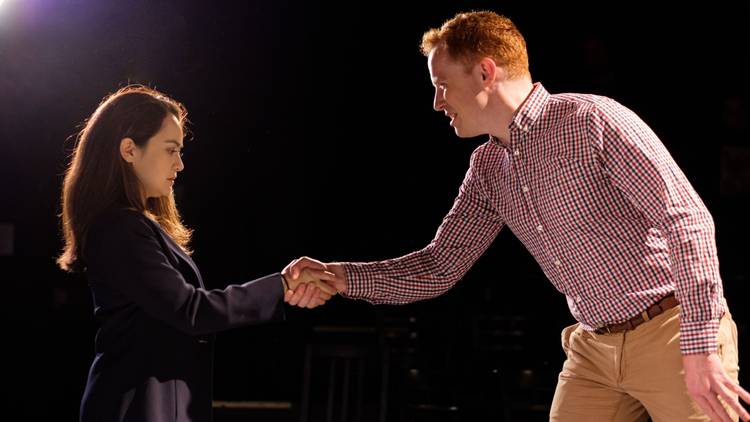 A man shakes  hands with a woman 