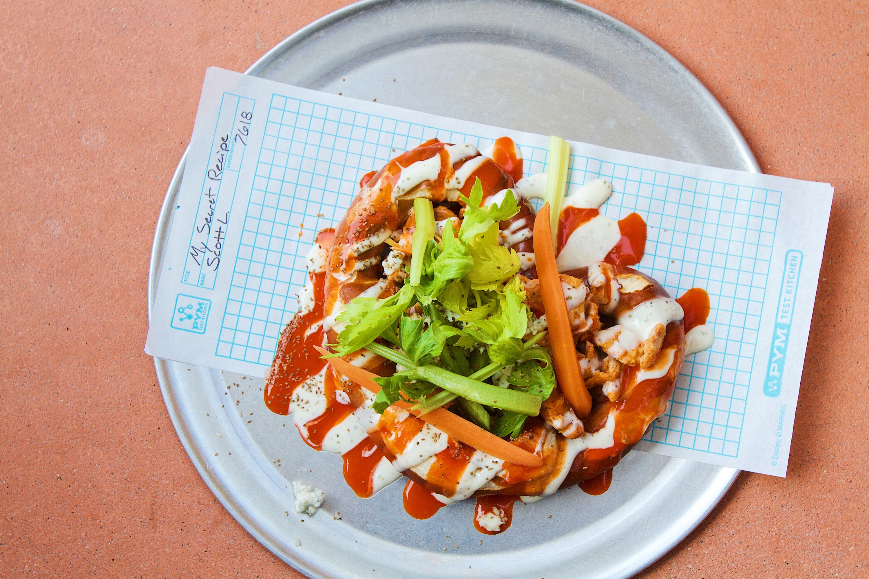 Atomic-style pretzel with Buffalo-style chicken, ranch, blue cheese, celery and pickled carrots