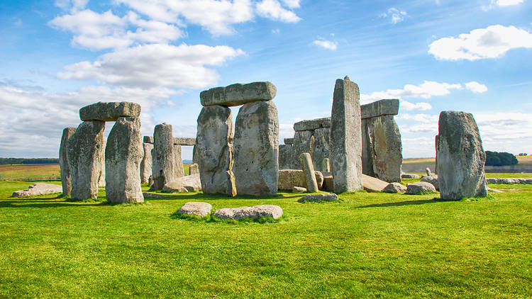 A view of Stonehenge on a bright, sunny day with little cloud overhead