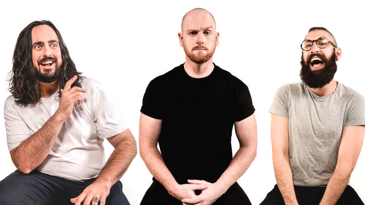 The Aunty Donna trio against a white background. Zach looks crazily bemused, Broden looks comically serious and Mark looks like he's having the time of his life. 