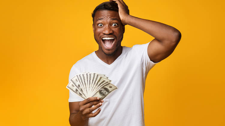 man holding a stack of hundred dollar bills