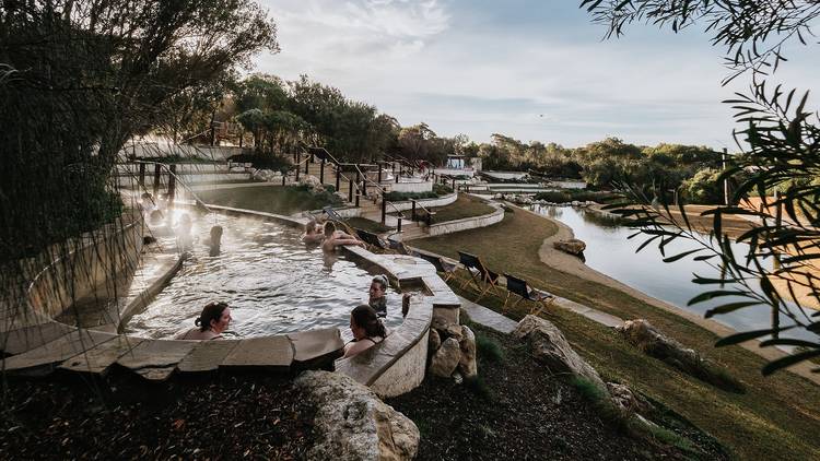 People bathing in tiered hot springs 