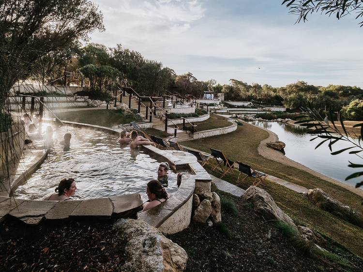 People bathing in tiered hot springs 