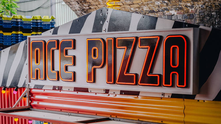 A woman in a pizza truck in a brick arch