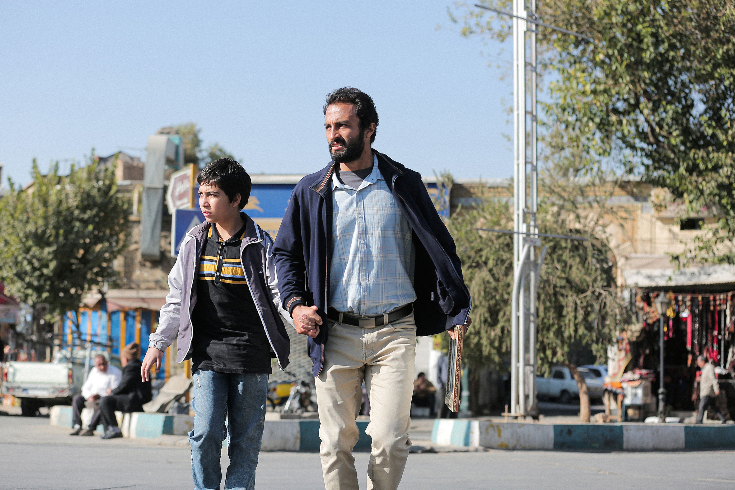 a man and a young boy on the streets of Shiraz in Iran