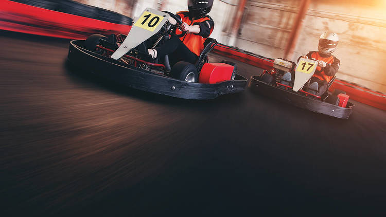 two people racing go karts 