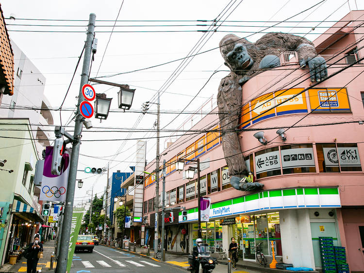 A three-storey commercial building with a large gorilla statue on top