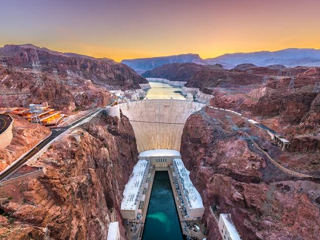 The Hoover Dam on the Colorado River Aerial shot of the concrete wall of the Hoover Dam at sunset