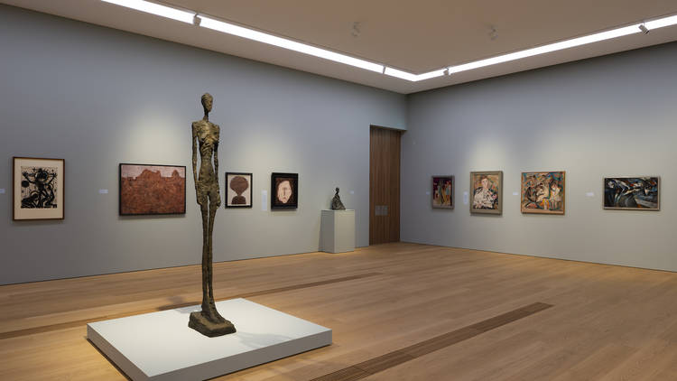 Paintings and a sculpture in a gallery at the Cantonal Museum of Fine Arts (MCBA).